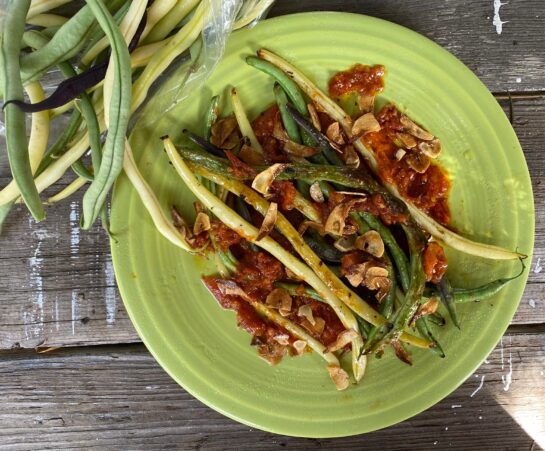 Pole Beans plated with Tomato Sauce and Toasted Garlic