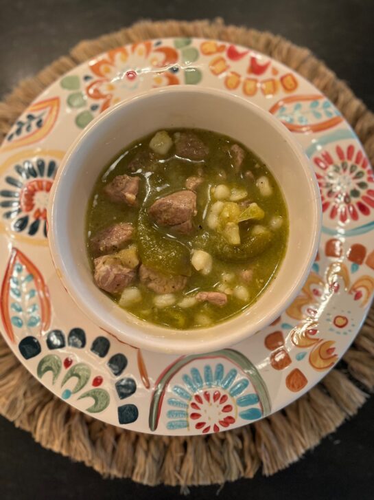 Birdseye View of PORK AND CHILE SOUP WITH TOMATILLOS soup on a decorated bowl