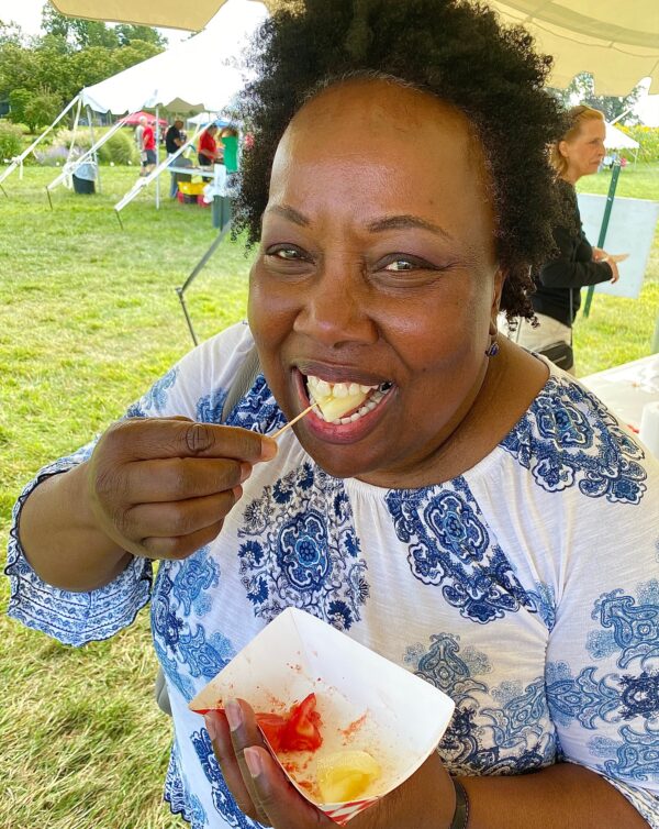 Princeton resident Brenda Bray sampling tomatoes at Snyder Farm